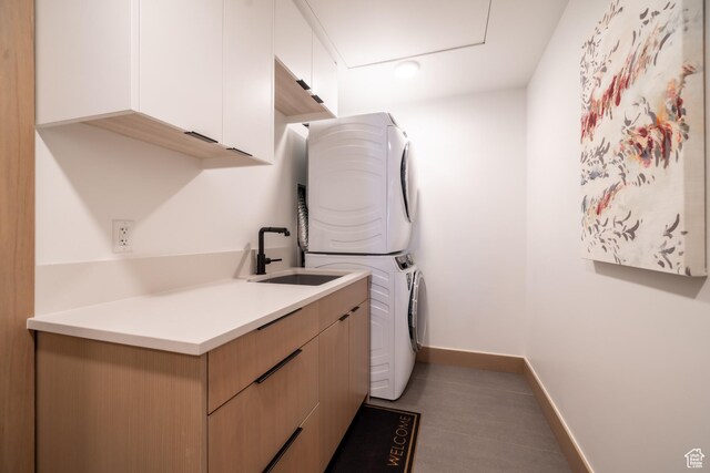 1271 Lowell Ave Unit D201, Park City, UT 84060 - washroom featuring stacked washer / dryer and cabinet space