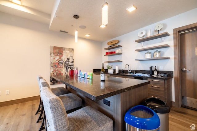 1271 Lowell Ave Unit D201, Park City, UT 84060 - indoor wet bar featuring light wood-type flooring and hanging light fixtures