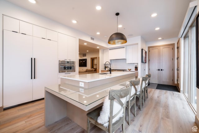 1271 Lowell Ave Unit D201, Park City, UT 84060 - kitchen featuring oven, modern cabinets, white cabinets, an island with sink, and recessed lighting