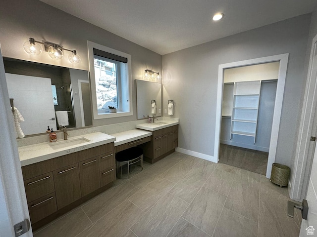 818 E Miner Way Unit 34, Hideout, UT 84036 - bathroom with baseboards, tiled shower, a sink, and two vanities