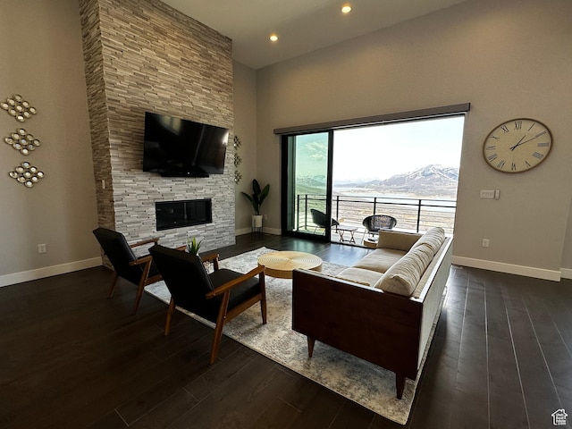 818 E Miner Way Unit 34, Hideout, UT 84036 - living room featuring a high ceiling, a stone fireplace, baseboards, recessed lighting, and dark wood-style flooring