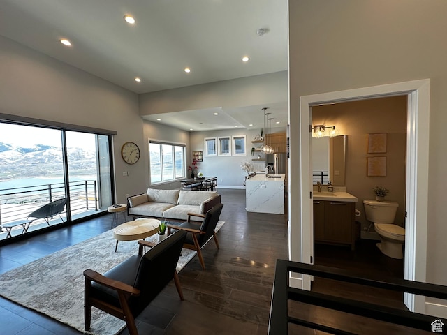 818 E Miner Way Unit 34, Hideout, UT 84036 - living area with a towering ceiling, dark wood-type flooring, baseboards, and recessed lighting