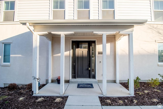 property entrance featuring stucco siding