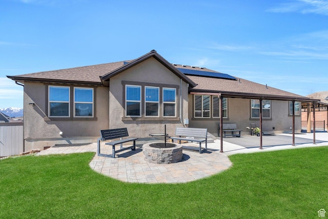9844 N Faust Station Dr W, Eagle Mountain, UT 84005 - rear view of property with a fire pit, stucco siding, a patio area, and a yard