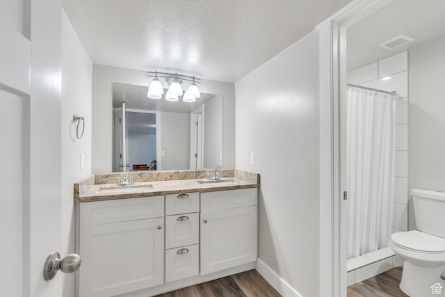 9844 N Faust Station Dr W, Eagle Mountain, UT 84005 - full bath with toilet, a sink, wood finished floors, and visible vents