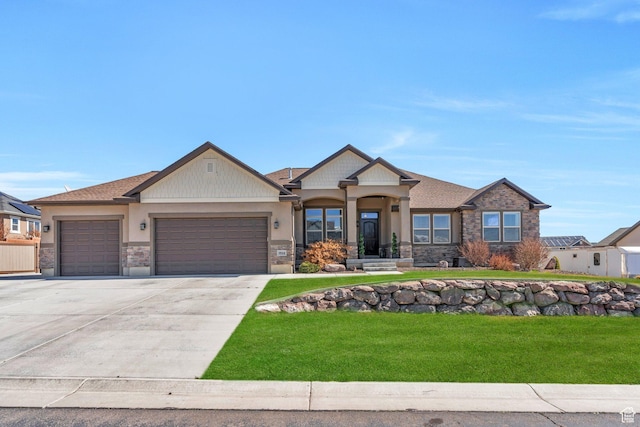 9844 N Faust Station Dr W, Eagle Mountain, UT 84005 - craftsman-style home with driveway, a front yard, an attached garage, and stone siding