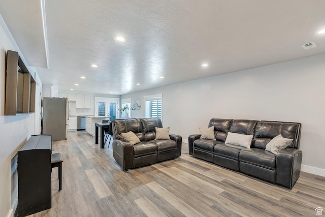 9844 N Faust Station Dr W, Eagle Mountain, UT 84005 - living area featuring baseboards, visible vents, light wood-style flooring, and recessed lighting