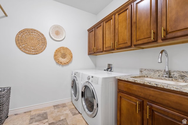 141 E Cottage Cv, Saratoga Springs, UT 84045 - washroom with a sink, cabinet space, washing machine and dryer, and baseboards