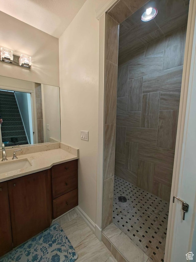 958 S Bridgecreek Ln, Layton, UT 84041 - bathroom with vanity, baseboards, and tiled shower