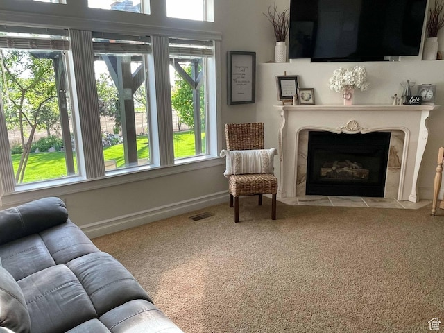 958 S Bridgecreek Ln, Layton, UT 84041 - carpeted living area featuring a fireplace with flush hearth, baseboards, and visible vents