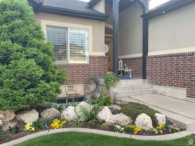 958 S Bridgecreek Ln, Layton, UT 84041 - details with brick siding, roof with shingles, and stucco siding