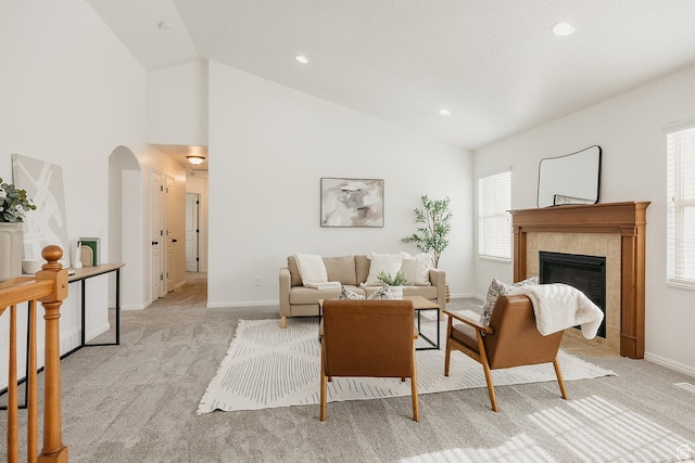 352 S 2000 E, Spanish Fork, UT 84660 - living area with light carpet, vaulted ceiling, arched walkways, and a tile fireplace