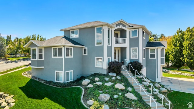 496 E Spruce Glen Rd, Murray, UT 84107 - view of front of house with a balcony, stucco siding, and a front yard