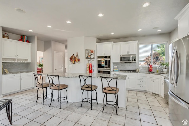 496 E Spruce Glen Rd, Murray, UT 84107 - kitchen with stainless steel appliances, backsplash, a kitchen island, white cabinets, and recessed lighting