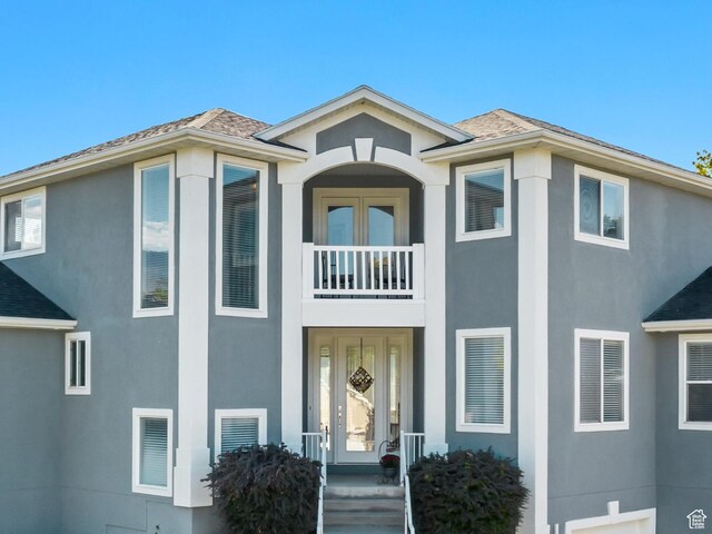 496 E Spruce Glen Rd, Murray, UT 84107 - view of front of home featuring a balcony, stucco siding, and roof with shingles
