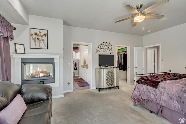 496 E Spruce Glen Rd, Murray, UT 84107 - bedroom featuring light carpet, a spacious closet, ensuite bathroom, baseboards, and ceiling fan