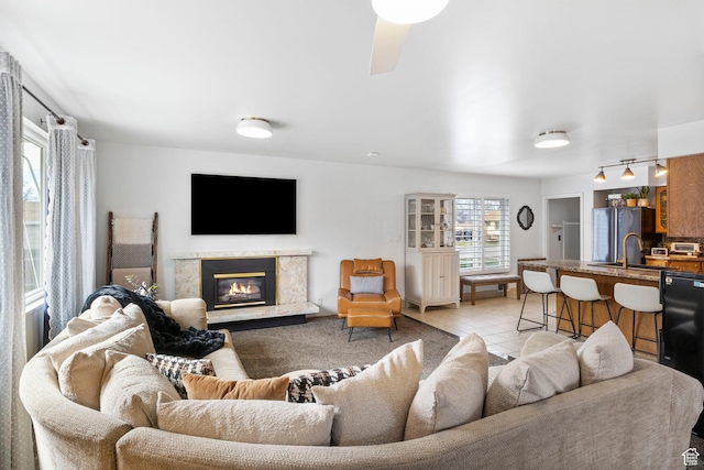 living area featuring light tile patterned floors and a premium fireplace