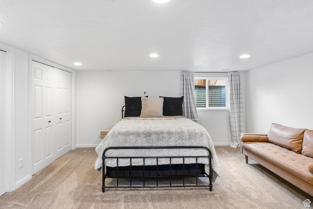 carpeted bedroom featuring baseboards and recessed lighting