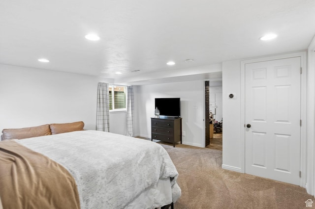 bedroom with baseboards, light colored carpet, and recessed lighting