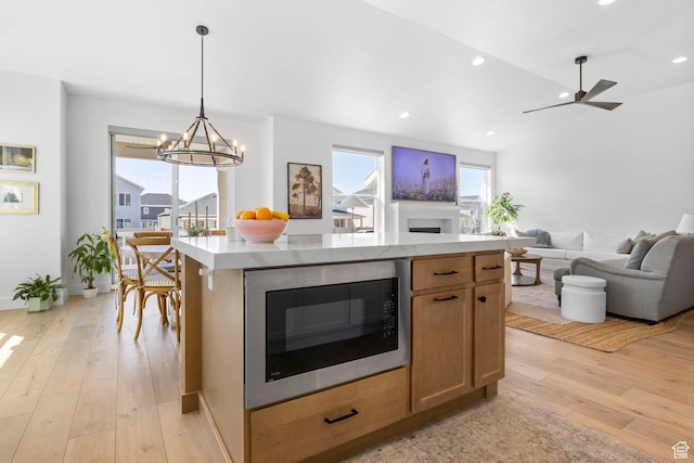 4947 W Evergreen Ln, Highland, UT 84003 - kitchen with light countertops, recessed lighting, light wood-style floors, open floor plan, and built in microwave