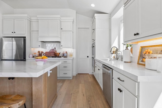 4947 W Evergreen Ln, Highland, UT 84003 - kitchen with light stone countertops, stainless steel appliances, lofted ceiling, a sink, and backsplash