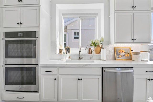 4947 W Evergreen Ln, Highland, UT 84003 - kitchen featuring tasteful backsplash, stainless steel appliances, a sink, white cabinets, and light stone countertops