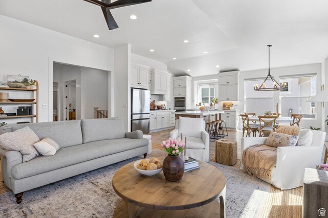 4947 W Evergreen Ln, Highland, UT 84003 - living area featuring ceiling fan with notable chandelier, a healthy amount of sunlight, lofted ceiling, and recessed lighting