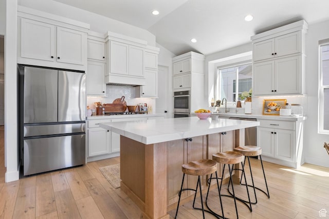 4947 W Evergreen Ln, Highland, UT 84003 - kitchen with decorative backsplash, lofted ceiling, stainless steel appliances, and light wood finished floors
