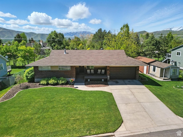 32 E 500 S, Midway, UT 84049 - ranch-style home with a garage, concrete driveway, a mountain view, brick siding, and a shingled roof