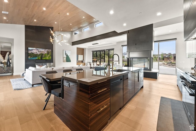 7290 Foxglove Ct, Park City, UT 84098 - kitchen with open floor plan, a large island with sink, stainless steel dishwasher, a sink, and modern cabinets