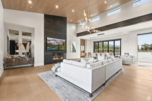 7290 Foxglove Ct, Park City, UT 84098 - living area with a large fireplace, light wood finished floors, recessed lighting, a high ceiling, and wood ceiling