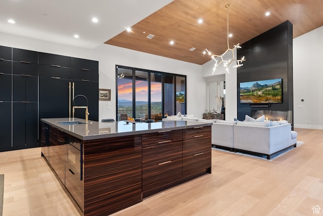 7290 Foxglove Ct, Park City, UT 84098 - kitchen with light wood finished floors, modern cabinets, a sink, a large island with sink, and wooden ceiling