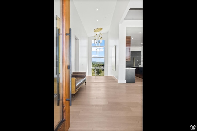 7290 Foxglove Ct, Park City, UT 84098 - hallway featuring an inviting chandelier, light wood-style flooring, and lofted ceiling