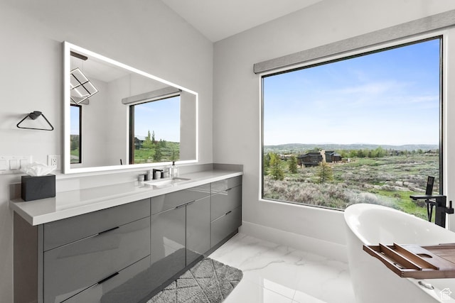 7290 Foxglove Ct, Park City, UT 84098 - bathroom featuring marble finish floor, baseboards, a freestanding bath, and a healthy amount of sunlight