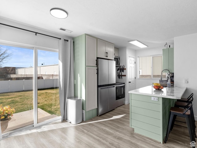 1929 W 680 N, Pleasant Grove, UT 84062 - kitchen featuring a wealth of natural light, visible vents, a kitchen breakfast bar, and appliances with stainless steel finishes