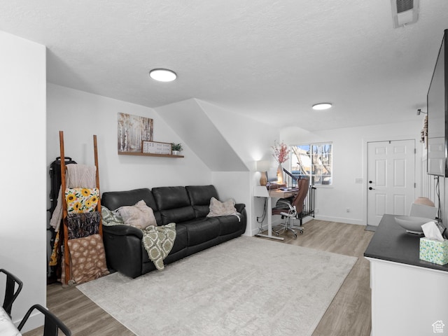1929 W 680 N, Pleasant Grove, UT 84062 - living area featuring a textured ceiling, lofted ceiling, baseboards, visible vents, and light wood-style floors