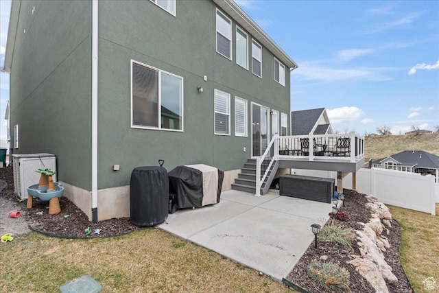 1321 E Daffodil Ct N Unit 155, Layton, UT 84040 - back of property with fence, a wooden deck, a garage, central AC, and a patio area