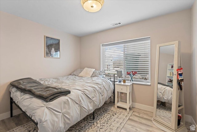 1321 E Daffodil Ct N Unit 155, Layton, UT 84040 - bedroom with light wood finished floors, baseboards, and visible vents