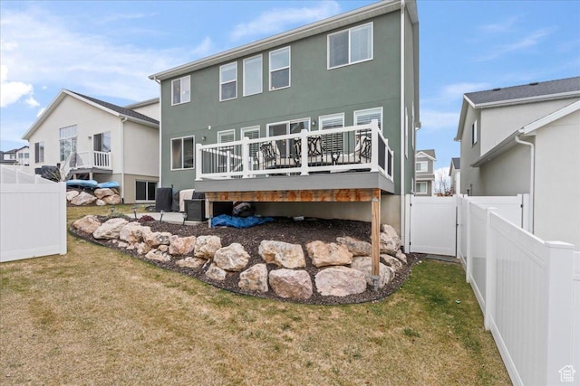 1321 E Daffodil Ct N Unit 155, Layton, UT 84040 - back of property featuring a lawn, a gate, a deck, and stucco siding