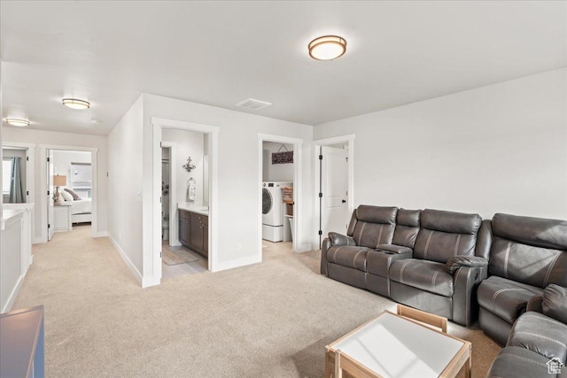 1321 E Daffodil Ct N Unit 155, Layton, UT 84040 - living room with baseboards, visible vents, washer / dryer, and light colored carpet