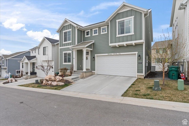 1321 E Daffodil Ct N Unit 155, Layton, UT 84040 - view of front facade featuring driveway, a garage, and board and batten siding