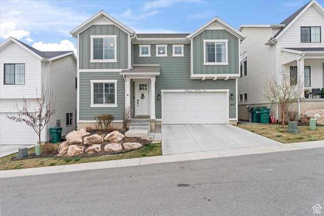 view of front of property with a garage, board and batten siding, and concrete driveway