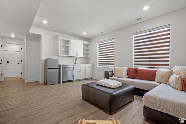 217 S Buckhorn Bath Ave W, Saratoga Springs, UT 84045 - living area with visible vents, light wood-style flooring, baseboards, recessed lighting, and wet bar