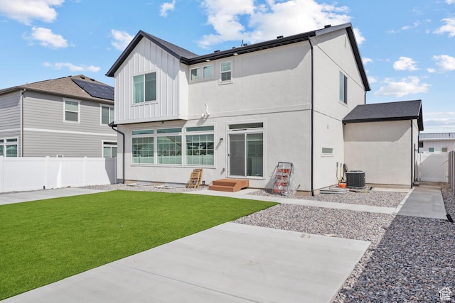 217 S Buckhorn Bath Ave W, Saratoga Springs, UT 84045 - back of house with stucco siding, central air condition unit, fence, board and batten siding, and a lawn