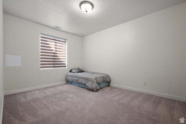 217 S Buckhorn Bath Ave W, Saratoga Springs, UT 84045 - carpeted bedroom with visible vents, baseboards, and a textured ceiling