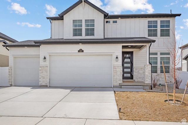 217 S Buckhorn Bath Ave W, Saratoga Springs, UT 84045 - view of front facade with driveway, an attached garage, stone siding, and board and batten siding