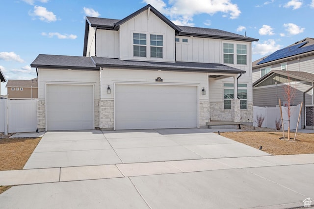 217 S Buckhorn Bath Ave W, Saratoga Springs, UT 84045 - view of front of house featuring stone siding, fence, board and batten siding, and concrete driveway