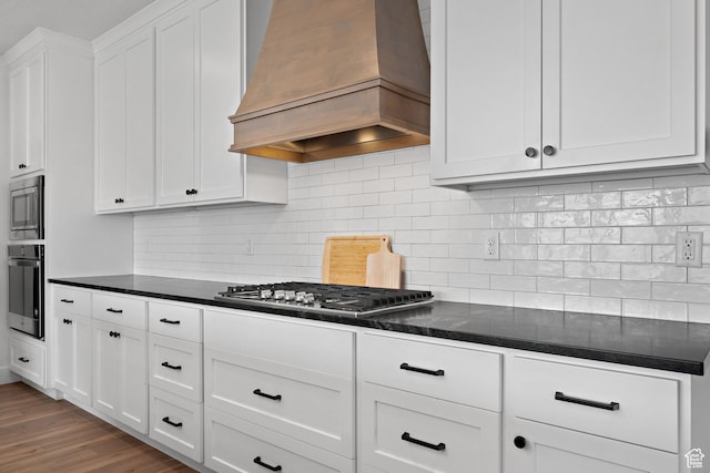 1807 S Bridle Path Loop, Lehi, UT 84043 - kitchen with wood finished floors, white cabinets, appliances with stainless steel finishes, tasteful backsplash, and custom exhaust hood