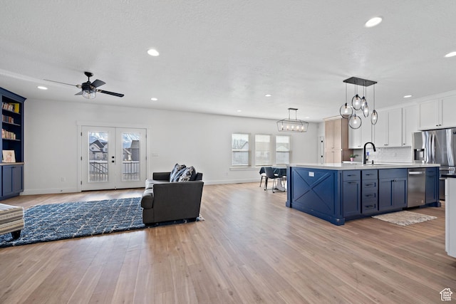 1807 S Bridle Path Loop, Lehi, UT 84043 - kitchen featuring dishwasher, ceiling fan with notable chandelier, open floor plan, light countertops, and white cabinets