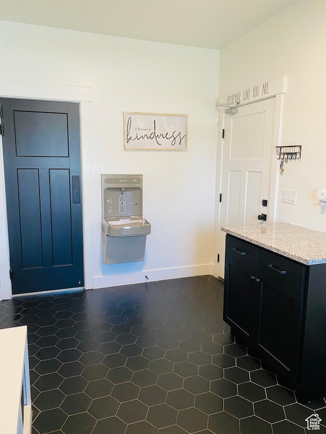 1807 S Bridle Path Loop, Lehi, UT 84043 - interior space with dark tile patterned flooring, baseboards, and light stone countertops